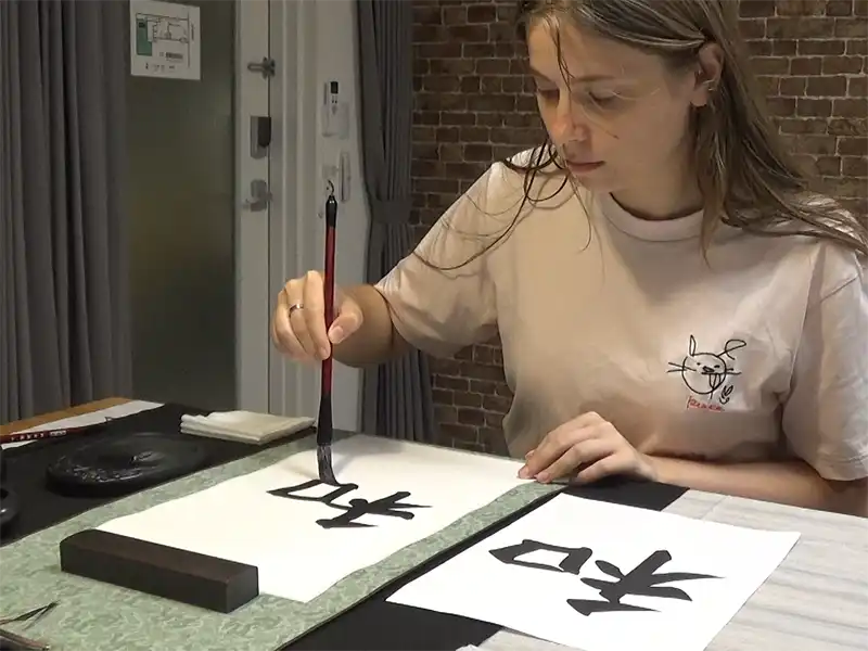 Practicing brush strokes on hanshi